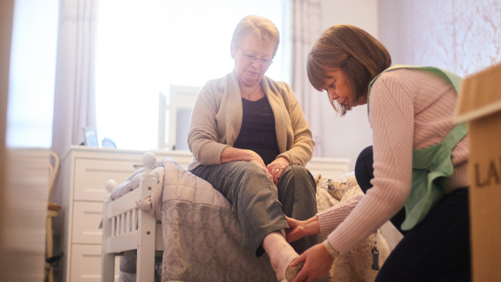 woman helping an elderly
