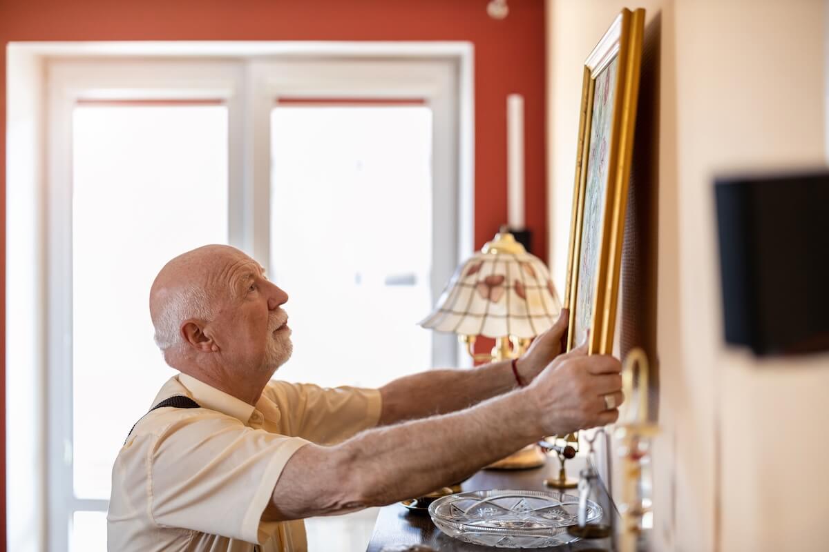 Older adult decorating his senior living apartment