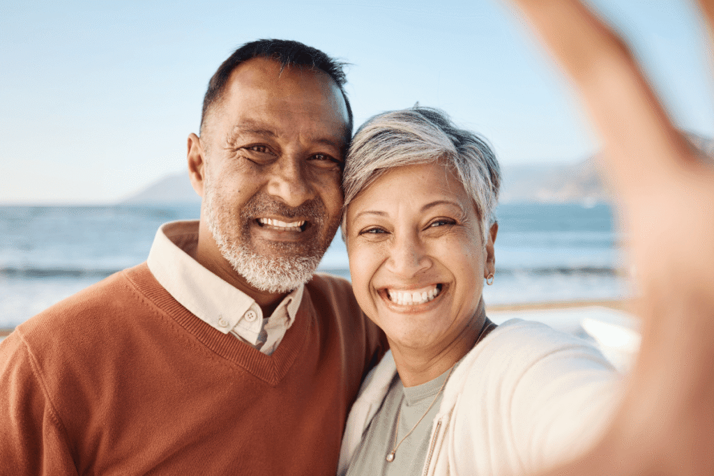 Senior couple, beach selfie and portrait with happy memory, care and bonding on vacation in summer sunshine. Man, woman and smile together for photography, profile picture or social media post by sea